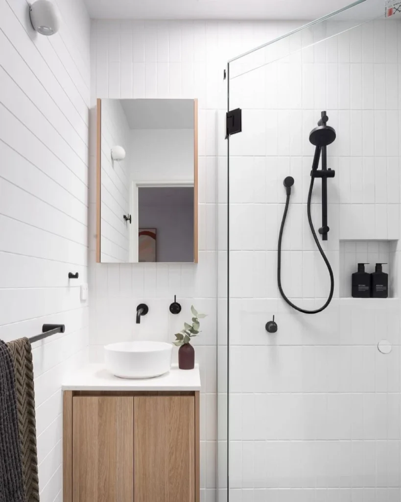 Simple White Bathroom With a Light Wood Vanity